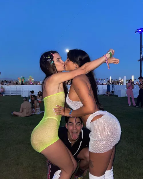 Claudia Tihan locking lips with a friend at Coachella by and-bob