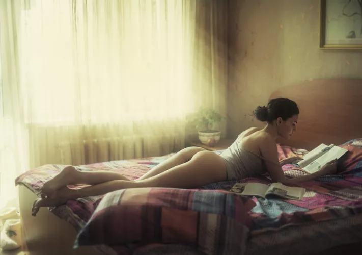 Reading on the bed by silveragecollector