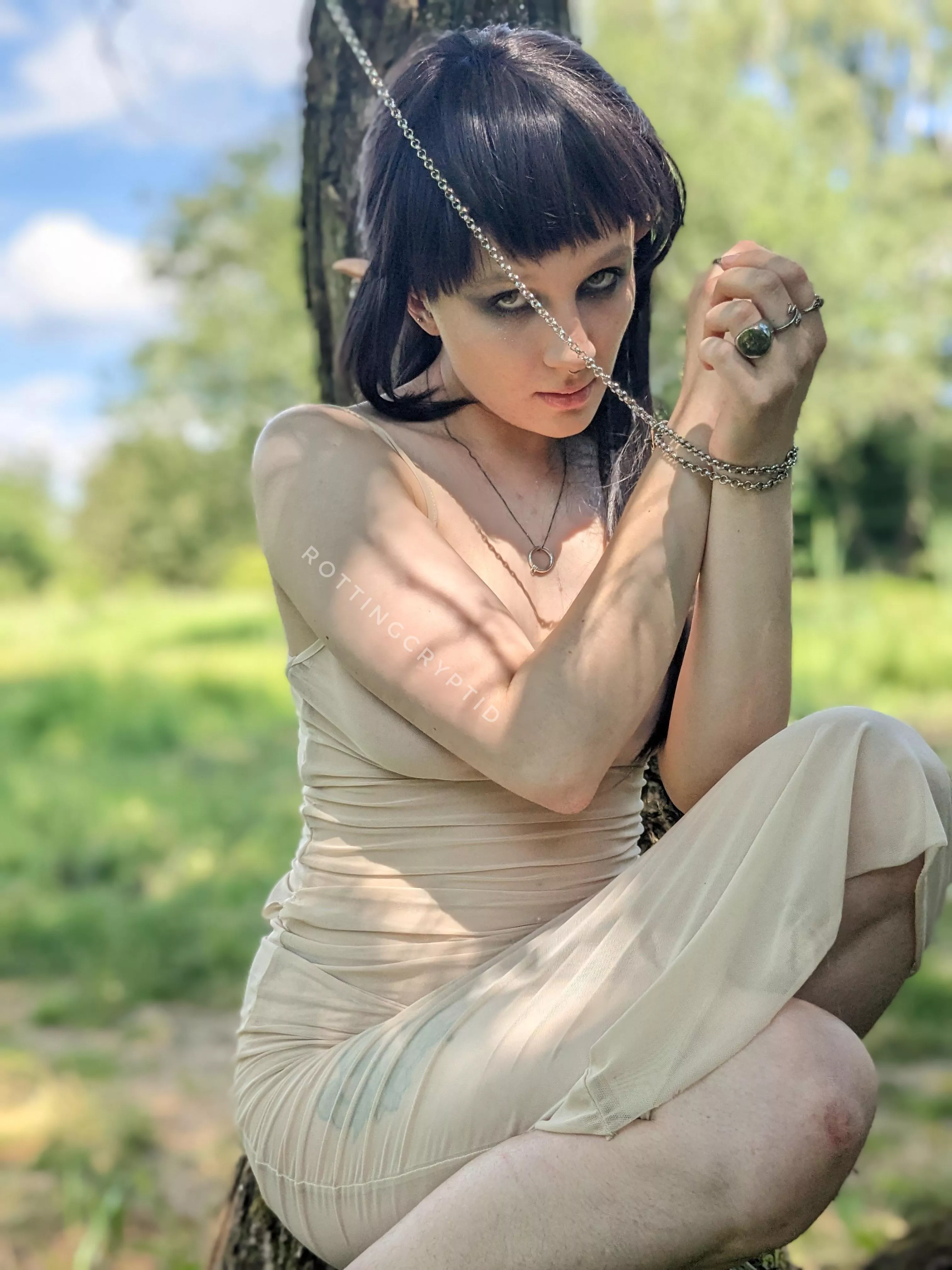 An elven creature chained to the tree posted by rottingcryptid