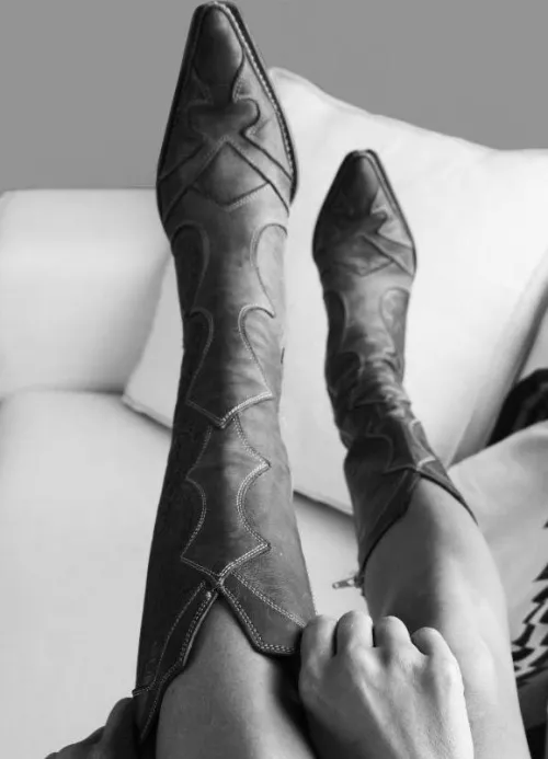 Please help me identify this brand / style of boots for my girlfriend. This photo was from a perfume ad. by the__rev