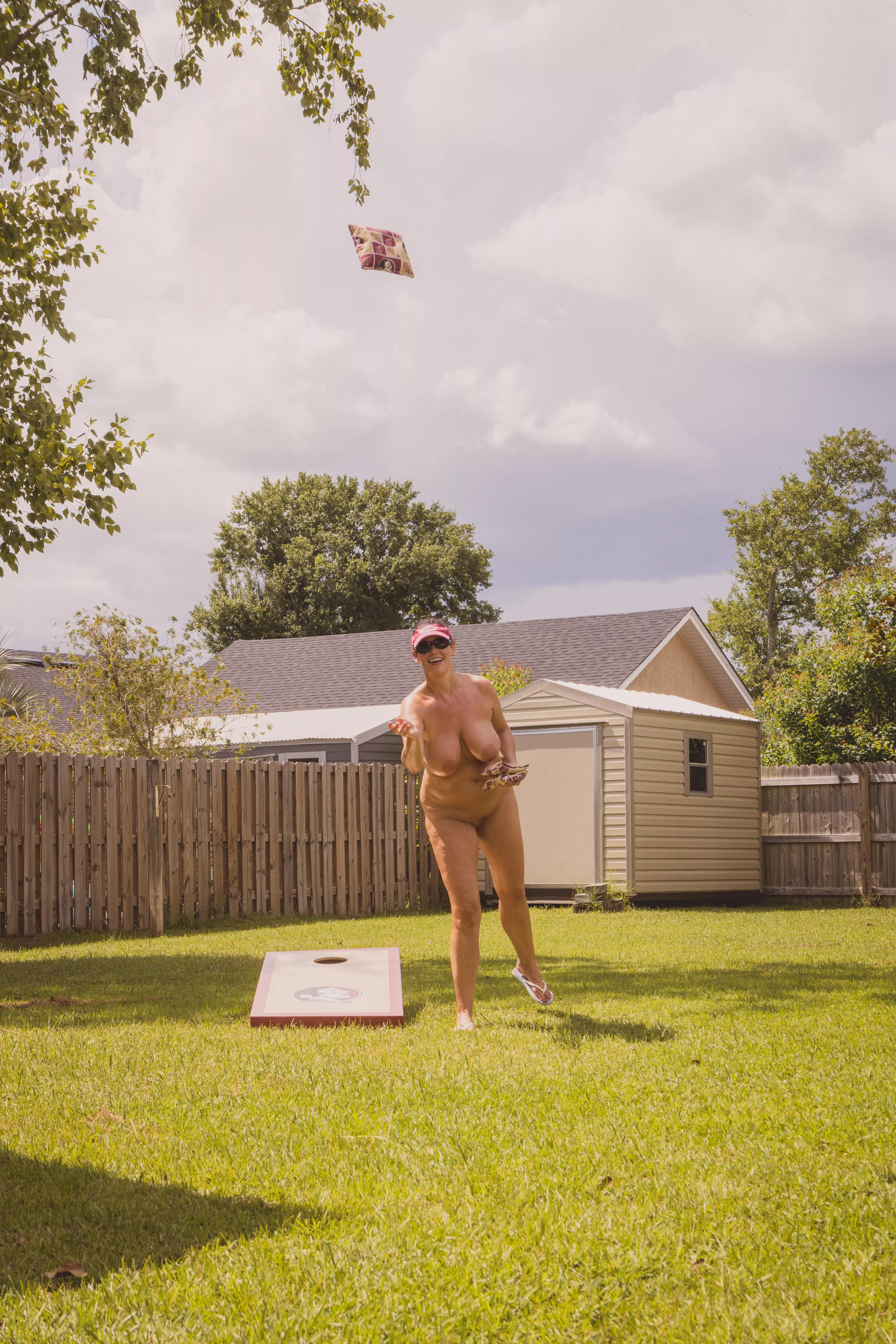 Playing cornhole posted by Nudephotobug