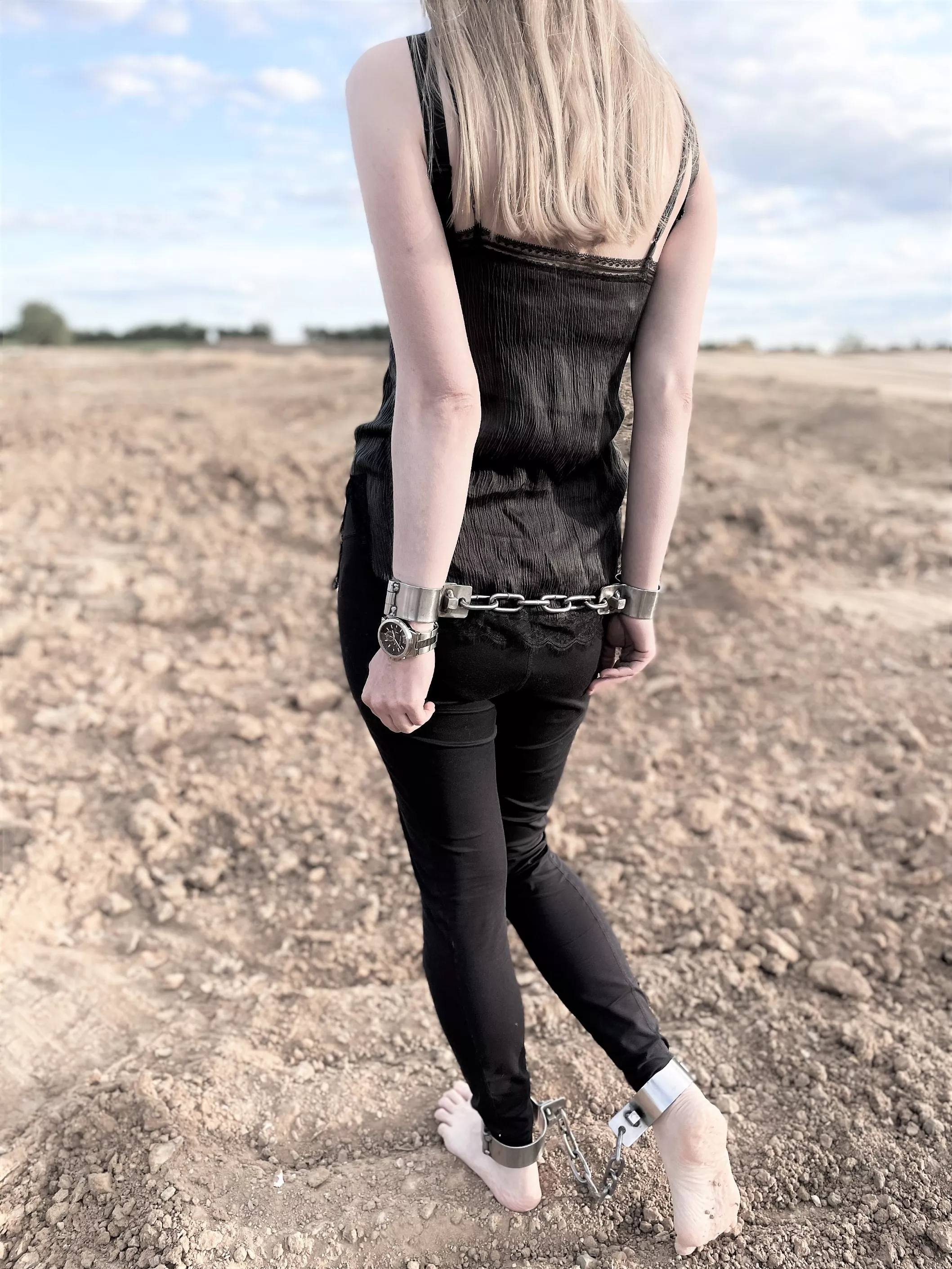 Shackled behind my back and made to walk across the wasteland barefoot posted by JessicaShackled