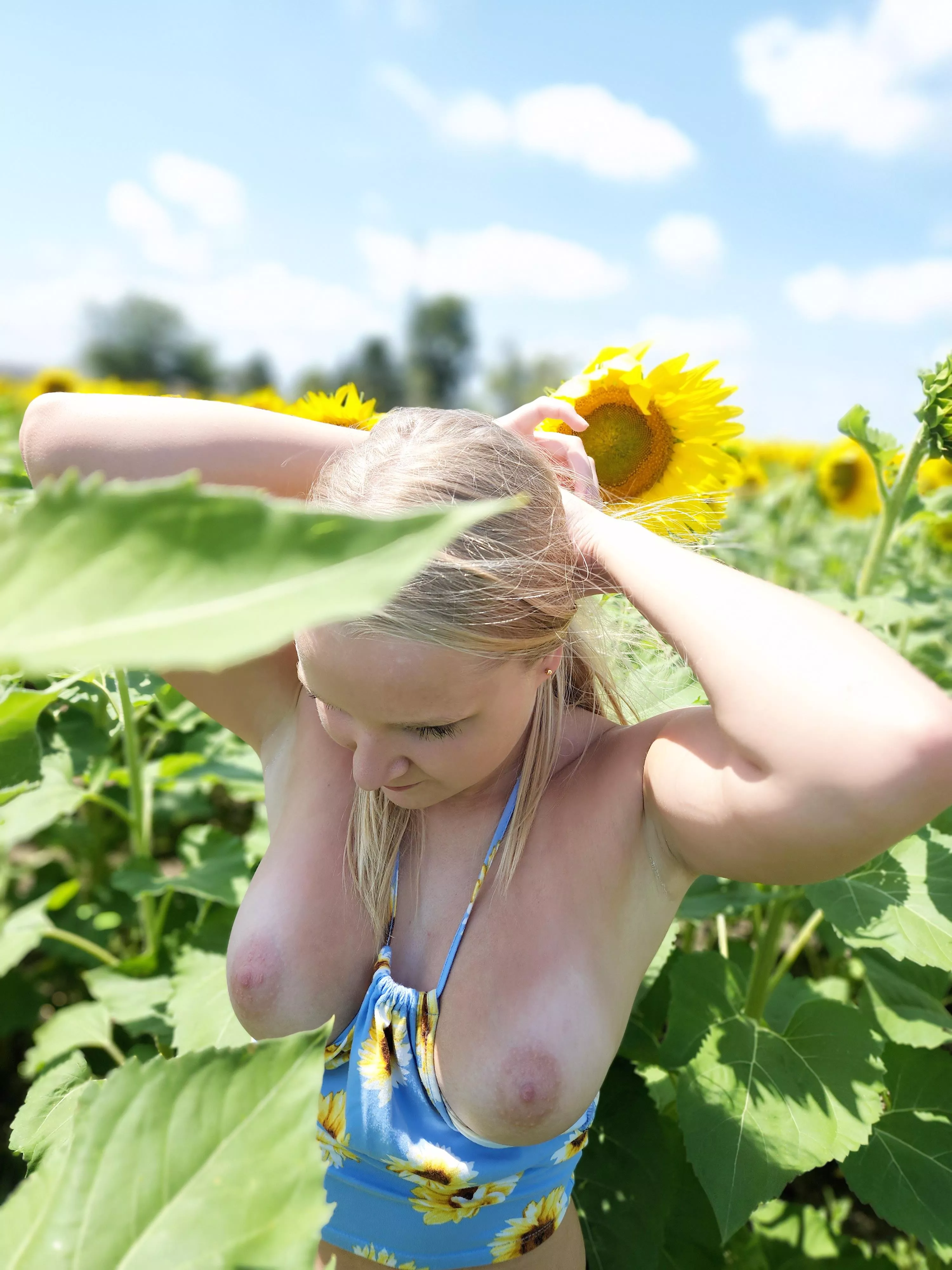 Pulling my hair back for a little fun in the sunflowers posted by Plucky_Peach