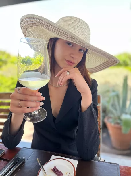 Classy woman drinks wine, cheers! posted by Marbellohe