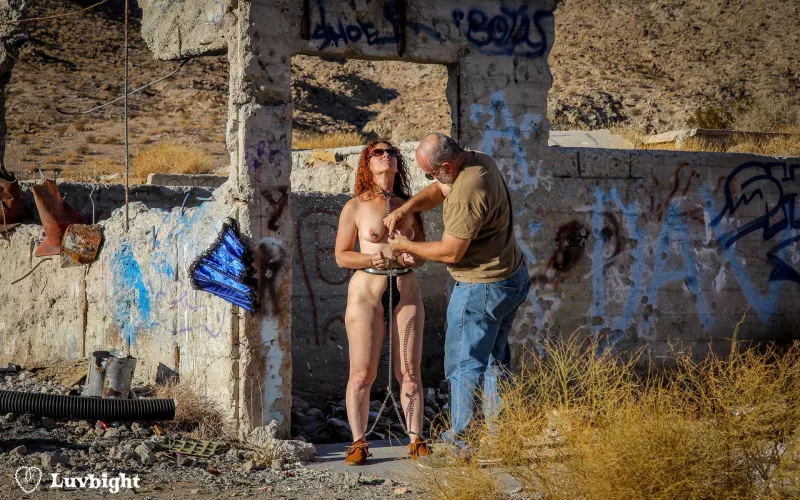A rare behind the scenes shot of my chaining a belted Dee Luvbight in the California desert for our Apocalypsy series (2011). This is the remains of a hospital building at Berdoo Water Camp. by MickLuvbight