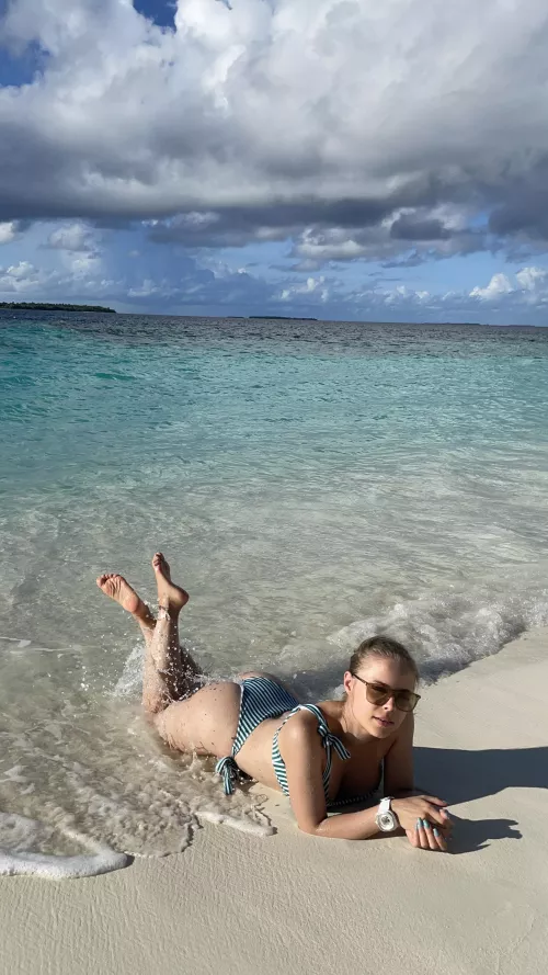 Bathing in the sun on an empty beach by adlenaline_