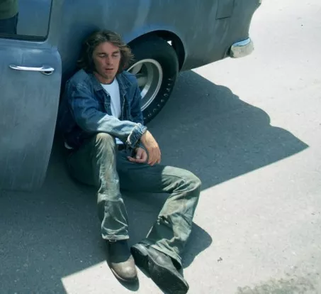 Can somebody ID this model of boot from Two-Lane Blacktop? Looks neat. Kinda like a roper, but not sure it is. posted by smellthepotatoes