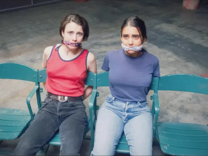 Margaret Qualley and Geraldine Viswanathan in Drive-Away Dolls by NotStPatrick