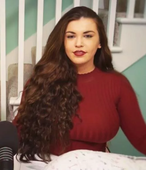 Podcaster in a red sweater posted by Desecr8or