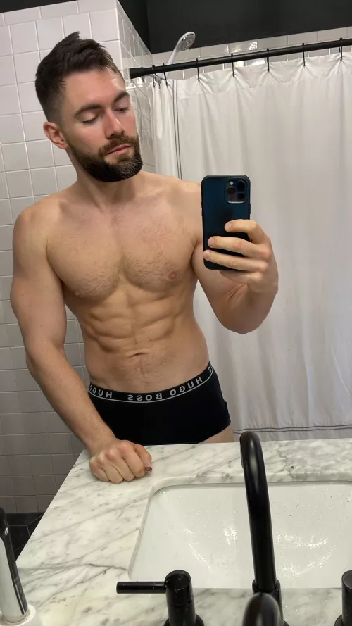 black Hugo Boss trunks against white marble by GriffinBarrows