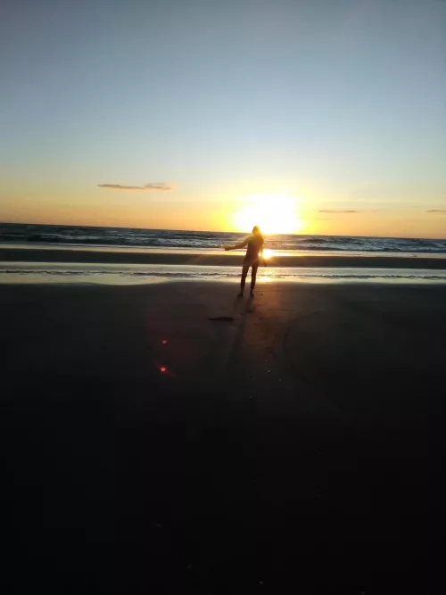 On the beach watching the sunrise by GinnaJaz