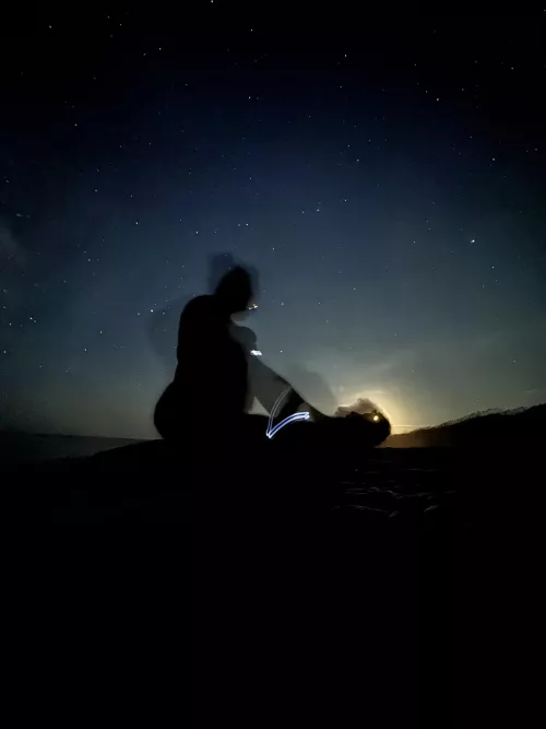 Playing on the beach at midnight, silhouetted against the moon by spicysundays