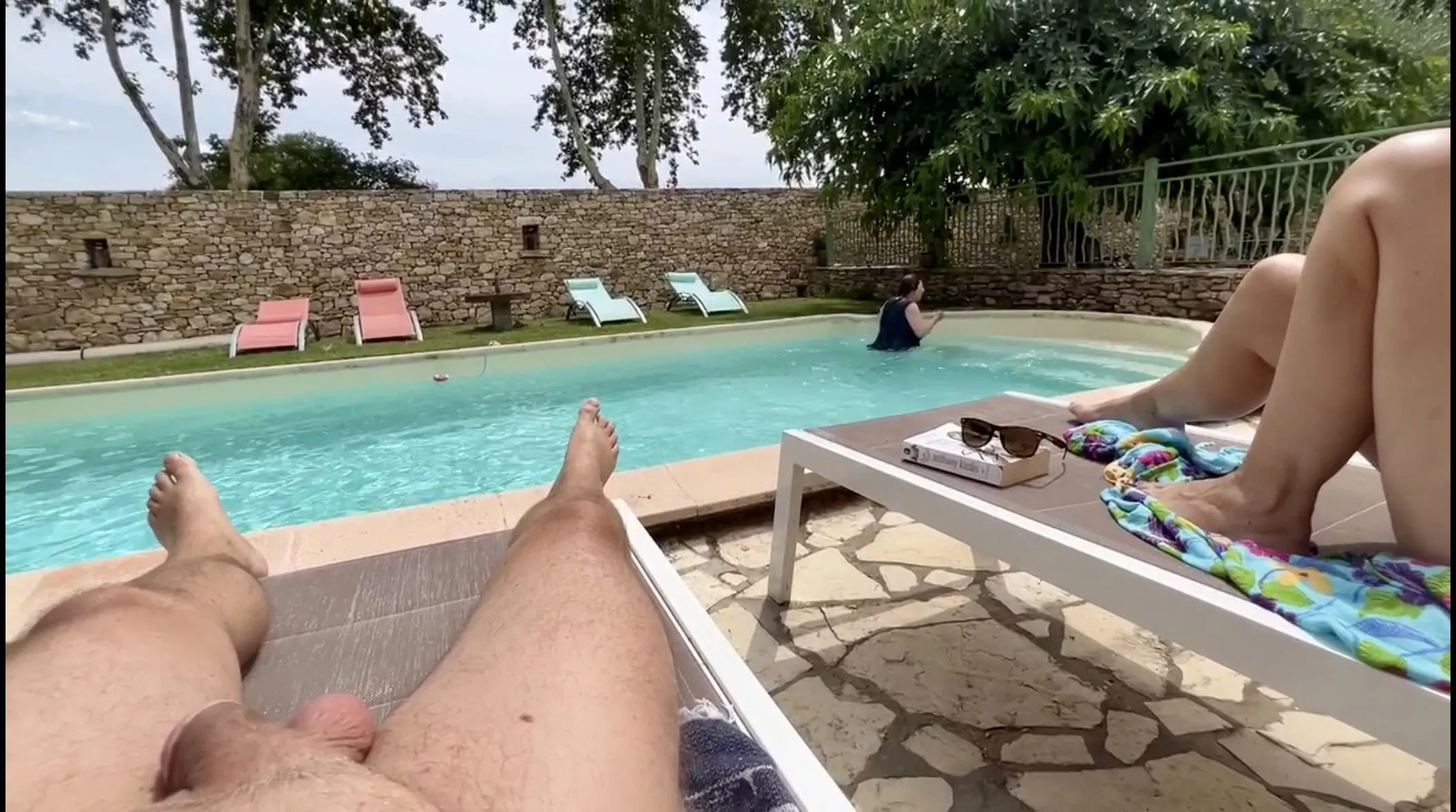 Hubby naked by our Airbnb pool while our clothed host has a swim. posted by Great_Personality862