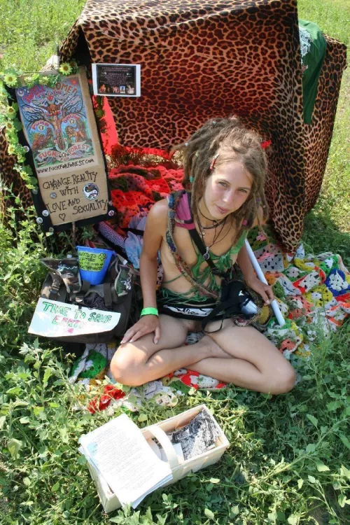 Leona, hippie Chick from fuck for forest selling something at a festival. nice dreads! by Imaginary-Ebb1932
