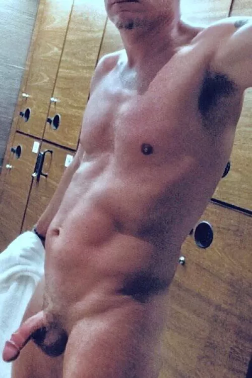 Me pulling towel away starting to get wood for pic in locker room. by textileno