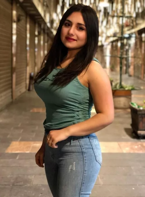 Brunette beauty in tank top & jeans by Due_Reputation_3525