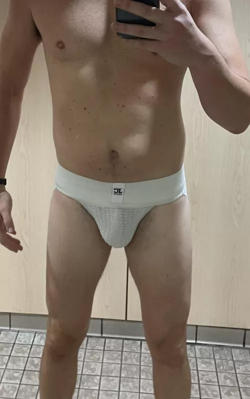 Classic white, wide-band jockstrap in the locker room this morning. Walked across the locker room to take the pic. by newarkewr