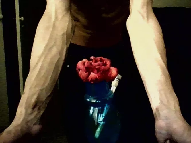 Forearms with flower in foreground🌺😌 by mastaan_on_the_moon