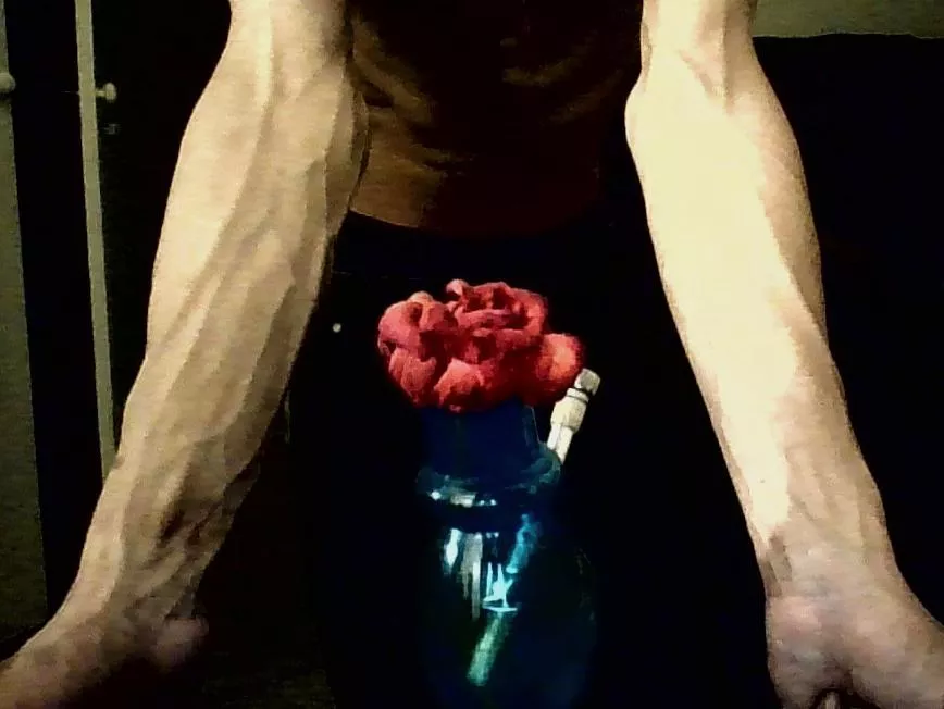 Forearms with flower in foreground🌺😌 posted by mastaan_on_the_moon