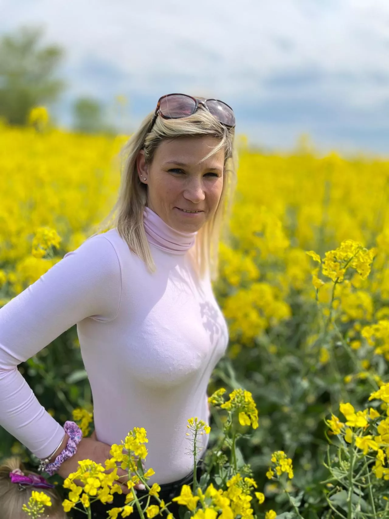 Bra lines beneath a tight pink top in a flowery field posted by BrownCrow11
