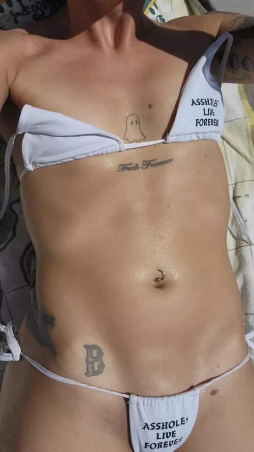 Tiny bikini and skin glistening with sweat by No_Tension8376