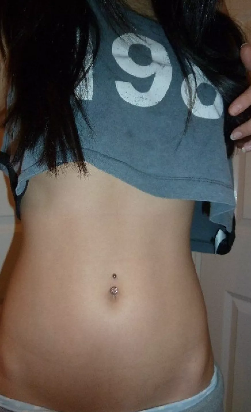 Cute crop top revealing a very sexy midriff and pierced belly button posted by thebellybuttonpage