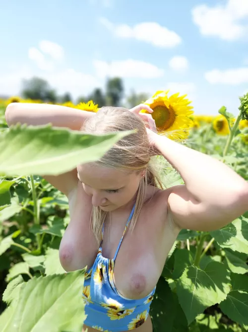 Pulling my hair back for a little fun in the sunflowers by Plucky_Peach