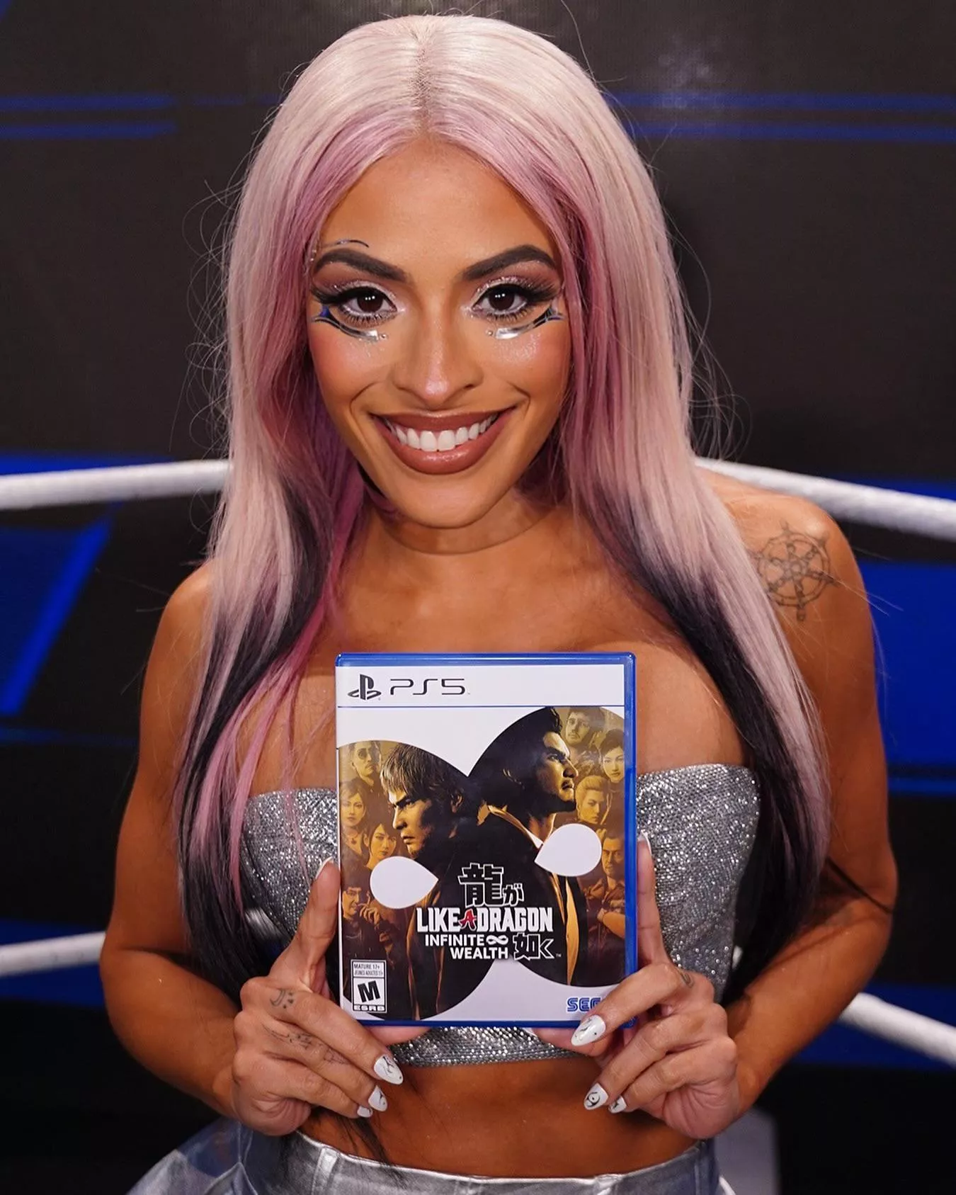 Zelina Vega (holding an all time classic) posted by SheetAcrobat