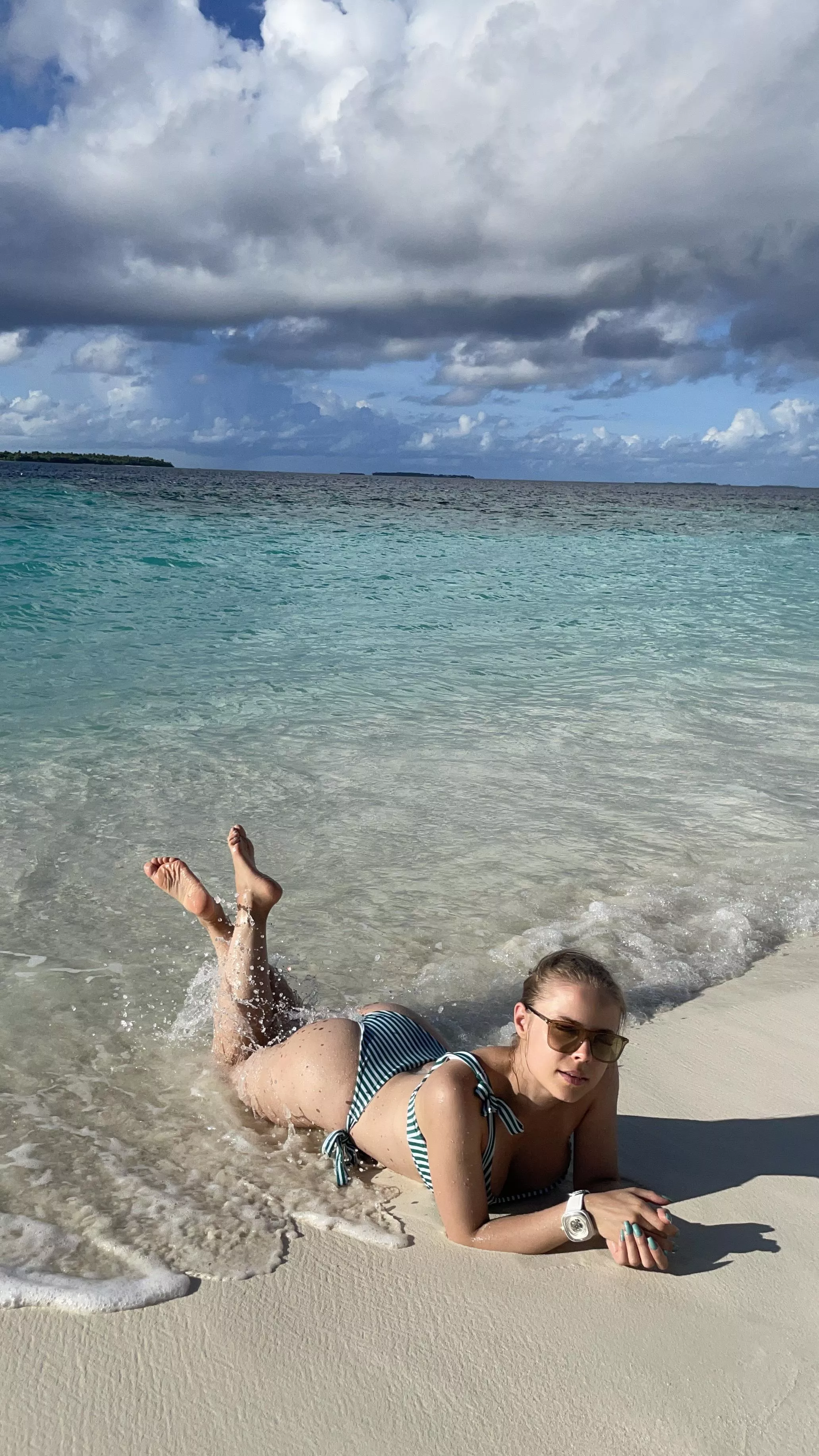 Bathing in the sun on an empty beach posted by adlenaline_