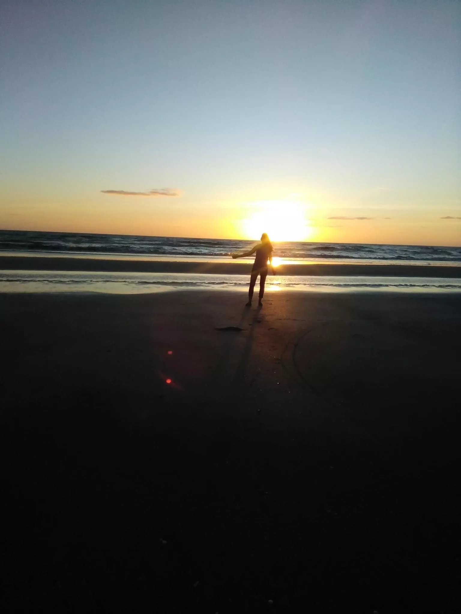 On the beach watching the sunrise posted by GinnaJaz