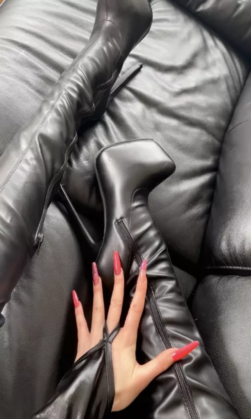 Leather boots on a leather couch by cerclavavz