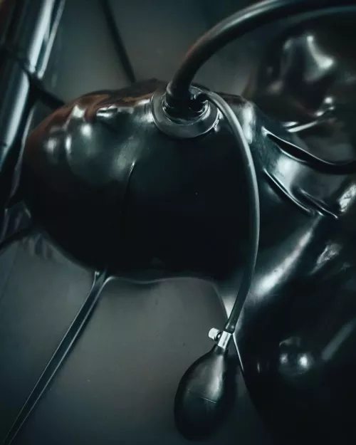 Fully encased in latex with an inflatable gag. Absolute restriction with a simple squeeze. by DominaDaemon
