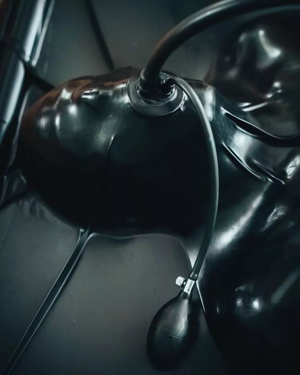 Fully encased in latex with an inflatable gag. Absolute restriction with a simple squeeze. posted by DominaDaemon