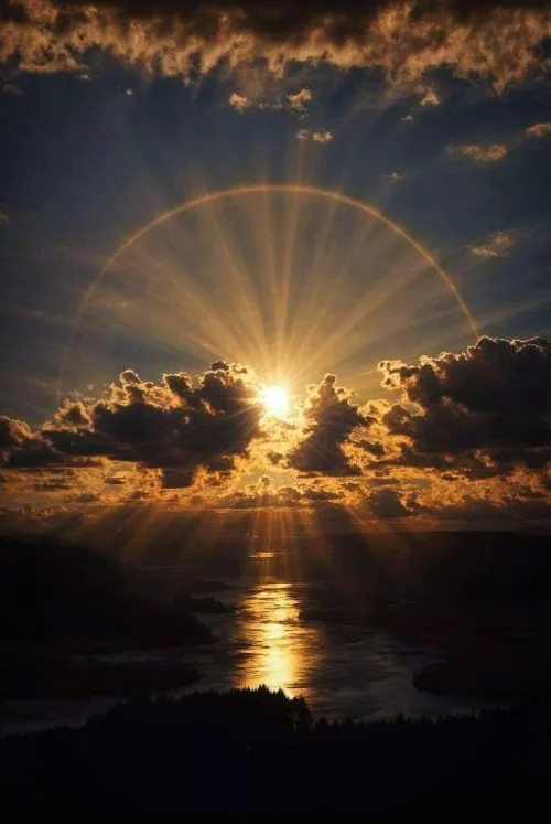 Circle of light on sun behind on huge cloud by kikkeealiodas