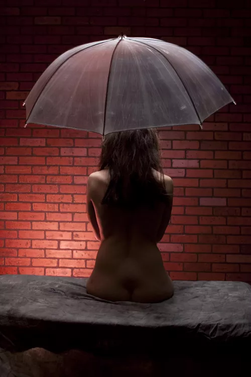 Brunette, waiting in the dark in front of the brick wall.  by ElderVixen