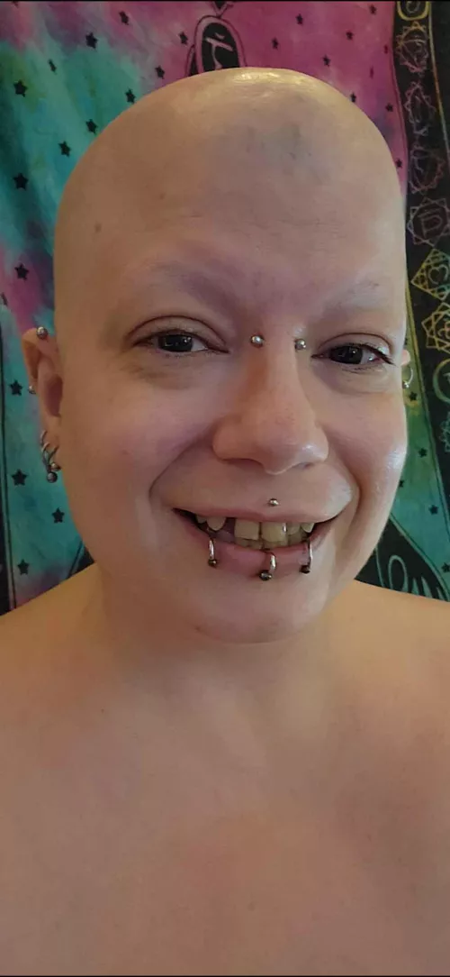Bald, pierced, shiny and smooth