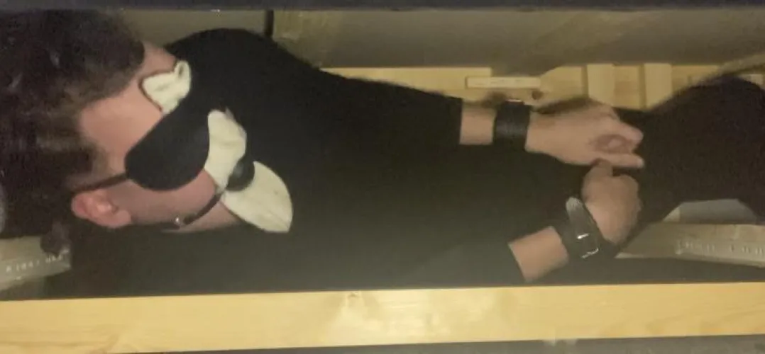 20 y/o male Stuffed in a dark wooden crate , mouth stuffed with socks held in by Ballgag , ankles and wrists cuffed , wearing tight black zip up jumpsuit , waiting to be sold at auction to spend my life as a bondage slave by Complete-Item8151