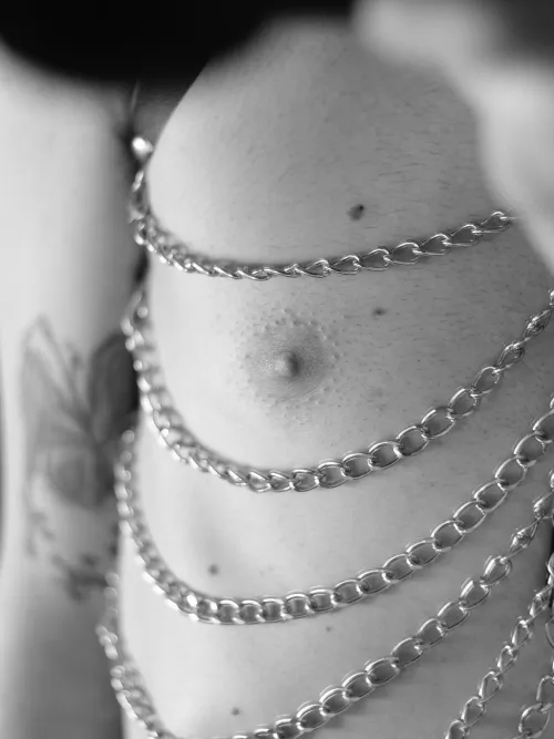 A close-up from my chest harness. I like how the chains fall and frame my button here  by glorified_in_iodine