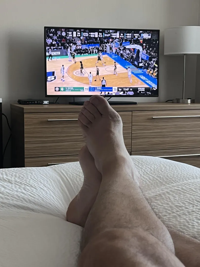 Dad (47) relaxing in my hotel room before my conference starts, and enjoying the start to the NCAA tourney. Would be extra nice if someone was rubbing my feet right now. posted by RubDadsFeet