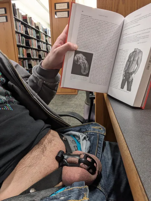 If you're going to take a caged pic in a library, you might as well do it with the book on dicks with a section on chastity by JerkOffToTitties