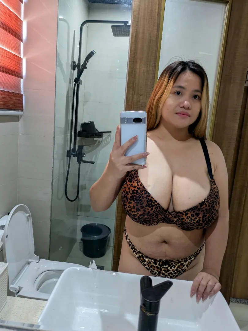 Mirror selfie glow catching the golden highlights in her hair and the depth of her cleavage posted by NewRegularPublic