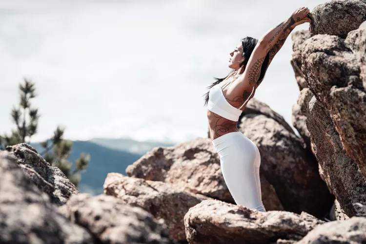 Basking in the sun in her yoga pants. by YogaPhotographer