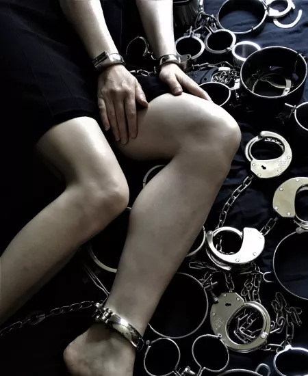 Cuffed and lying on (part of) the restraint collection by JessicaShackled