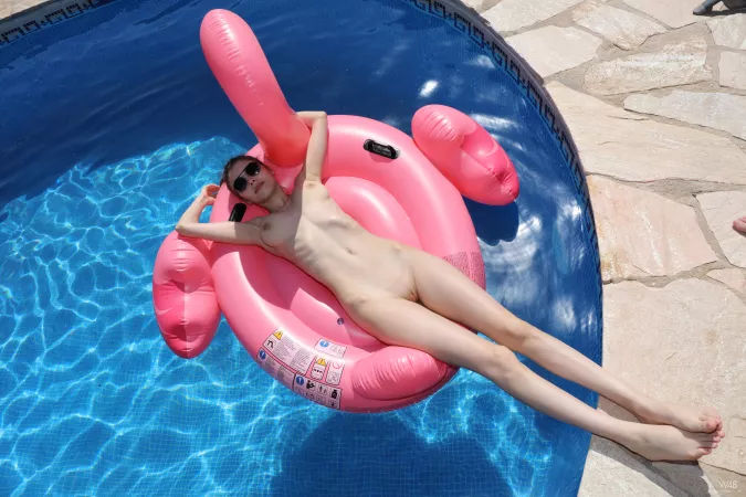 Mila Azul relaxing on a pink flamingo by [deleted]