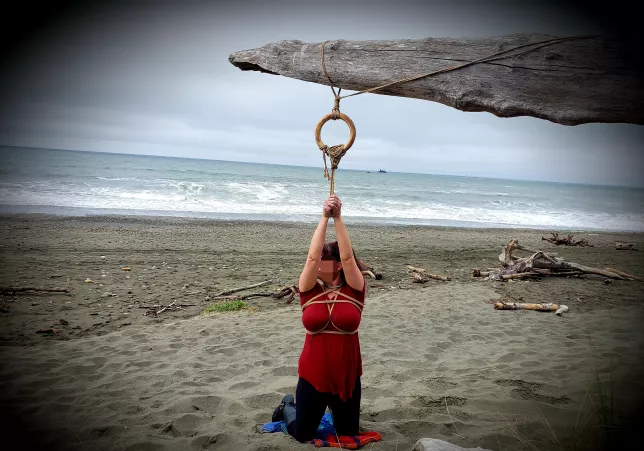 Ocean beach Shibari. [F]ound a quiet spot on the beach and the perfect driftwood to add a suspension ring. by FollowingOurDreams