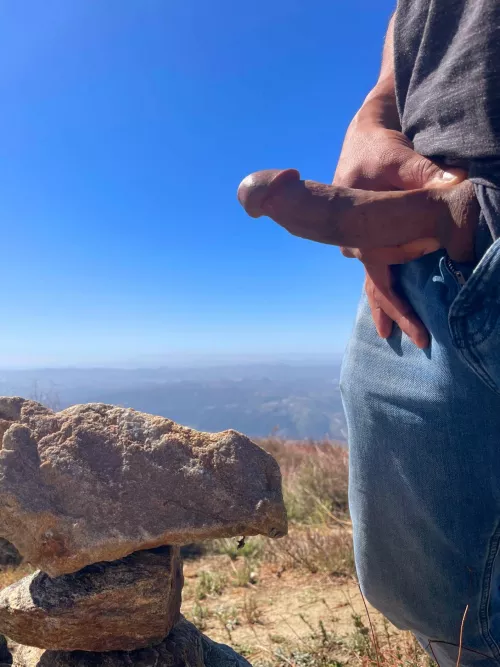 Rock stacking and cock flashing atop a mountain. by Phlip037