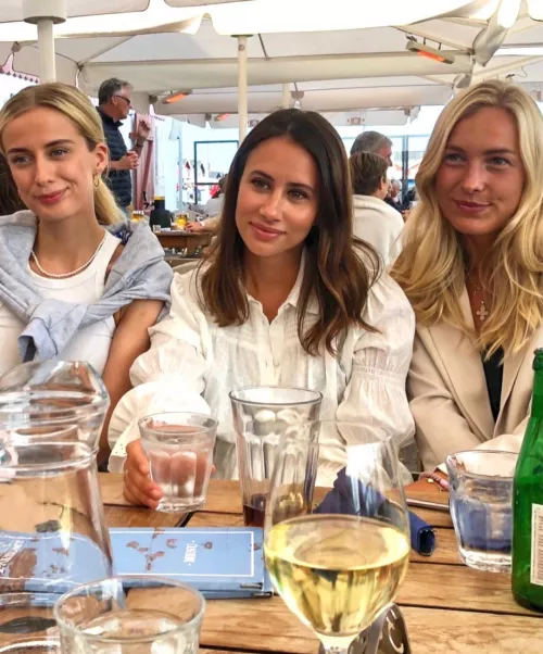 The girls leaning over the table by Master-Bug-1939