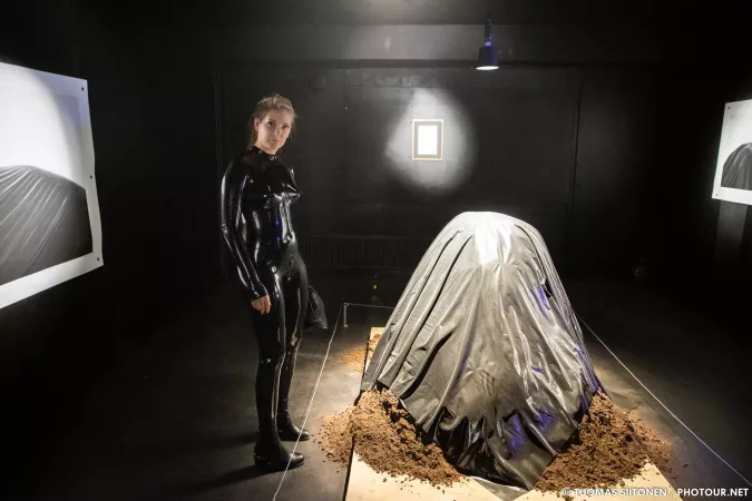 Wearing a latex catsuit to an art exhibition, we found a mound of dirt covered in latex as well by TuomasS